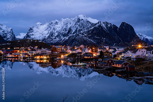 village reflection on water  in the northern sea cold winter frame, night view, blue hour