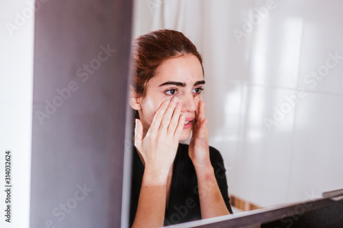 young woman with beauty face in the mirror