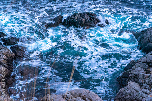waves on the rocks , northern sea coast, coastline frame, winter blue cold