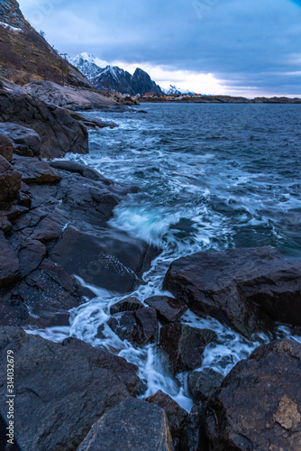 waves on the rocks , northern sea coast, coastline frame, winter blue cold