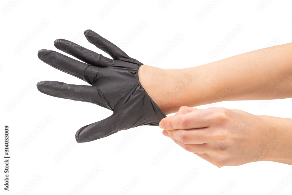 Woman puts on black rubber gloves.