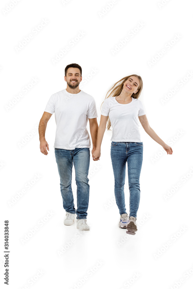 full length portrait of happy couple in casual outfit walking forward together on white background full length portrait of happy couple in casual outfit walking forward together on white background