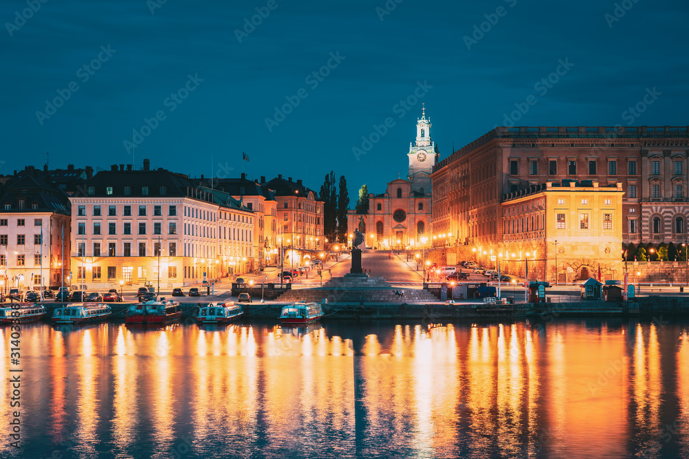 Stockholm, Sweden. Scenic Famous View Of Embankment In Old Town Of Stockholm In Night Lights. Great Church Or Church Of St. Nicholas And Royal Palace. Famous Popular Destination Scenic Place In Light