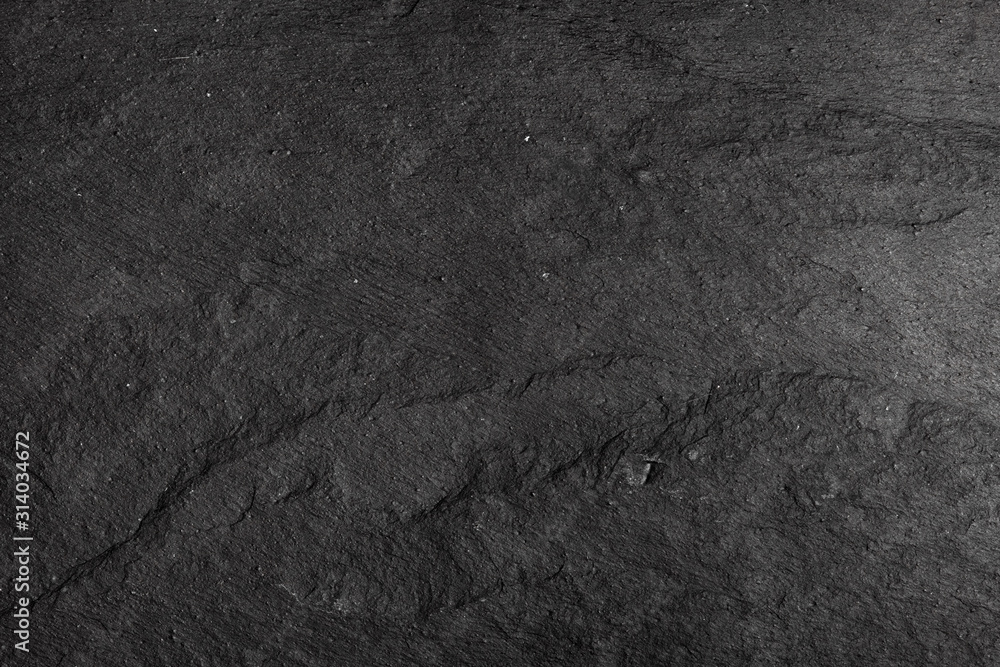 Dark gray black slate background or texture of natural stone. Black board for serving close-up Dark gray black slate background or texture of natural stone. Black board for serving close-up
