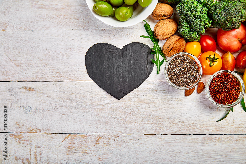 Background healthy food for heart. Healthy food, diet and life. Fresh fruits and vegetables, berries and nuts. Healthy heart concept. Top view, flat lay, Copy space. Background healthy food for heart. Healthy food, diet and life. Fresh fruits and vegetables, berries and nuts. Healthy heart concept. Top view, flat lay, Copy space.