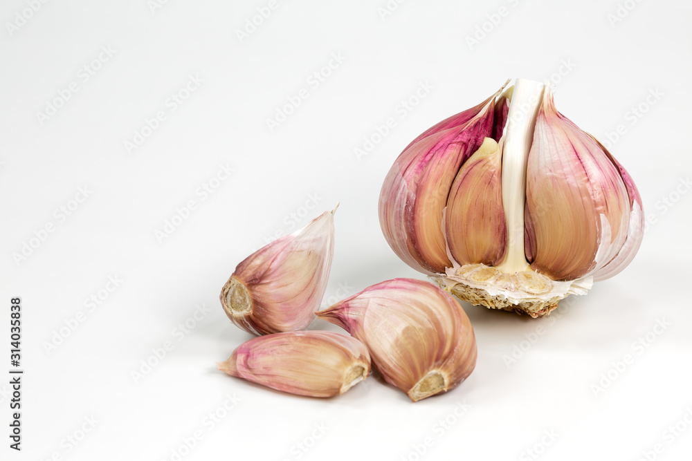a opened semi-peeled garlic bulb and cloves isolated on white background with copy space a opened semi-peeled garlic bulb and cloves isolated on white background with copy space