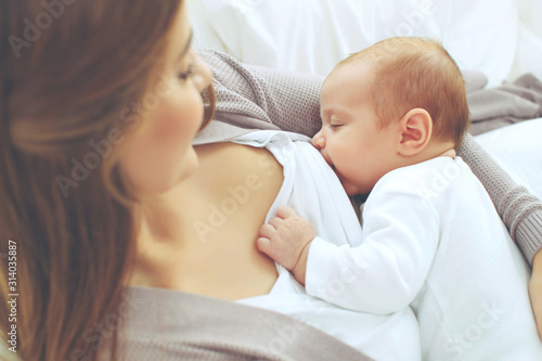 A woman is breastfeeding a baby. 