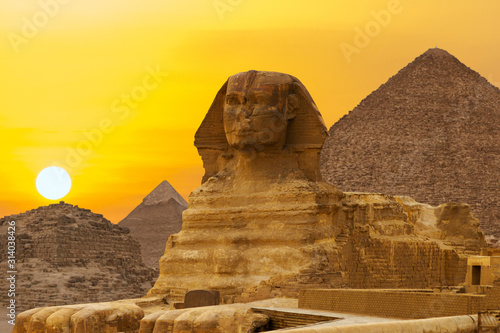 Sphinx against the backdrop of the great Egyptian pyramids. Africa, Giza Plateau.	 photo