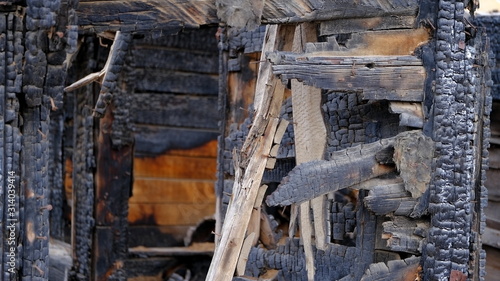  Old house after the fire. Burnt wooden details of an old residential building