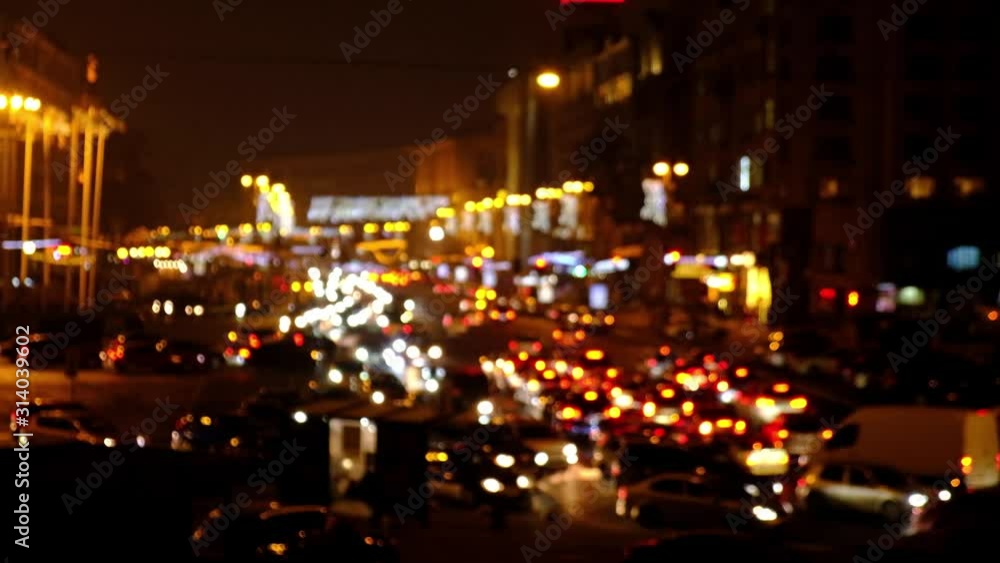 Defocused night city car traffic lights. Color blurred bokeh of moving transport and typical city view Defocused night city car traffic lights. Color blurred bokeh of moving transport and typical city view