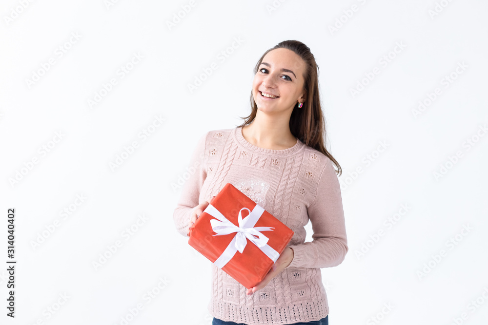 Holidays, valentine's day and festive concept - Beautiful smiling woman with long hair holding gift box. White background isolated studio portrait Holidays, valentine's day and festive concept - Beautiful smiling woman with long hair holding gift box. White background isolated studio portrait