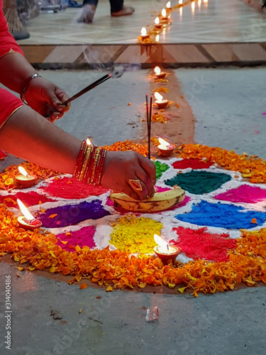Kathmandu, Nepal - October 27, 2019: Diwali, the Hindu festival of lights. People create rangoli, bright decorative patterns on the ground or floor made of colored rice, dry flour, colored sand etc.