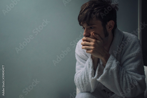 Depressed man in a dark room