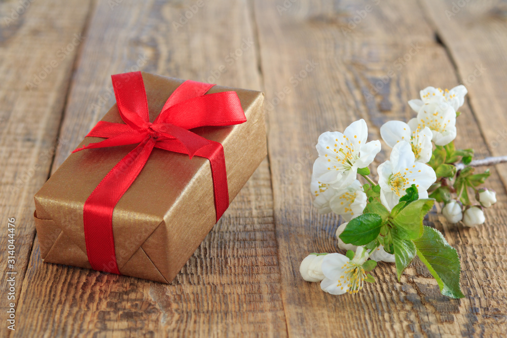 Gift box with flowers on the wooden background. Gift box with flowers on the wooden background.