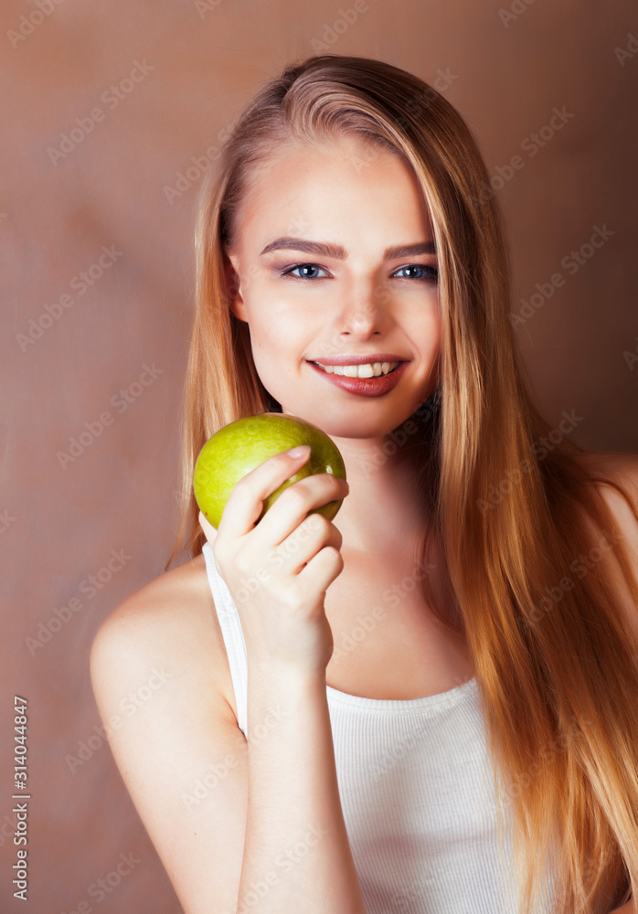 young pretty blond woman holding green apple smiling slim, lifestyle people concept young pretty blond woman holding green apple smiling slim, lifestyle people concept