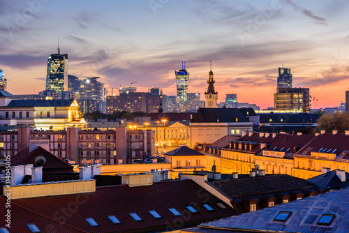 Cityscape of Warsaw at night. Roofs of the old town and skyscrapers against a beautiful sunset sky with illumination, Warsaw, Poland © r_andrei