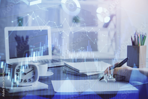 Financial graph displayed on woman's hand taking notes background. Concept of research. Multi exposure