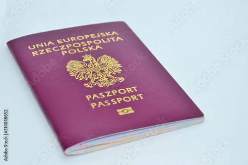 Polish biometric passport on white background. Selective focus. International travel document issued to nationals of Poland, a proof of Polish citizenship