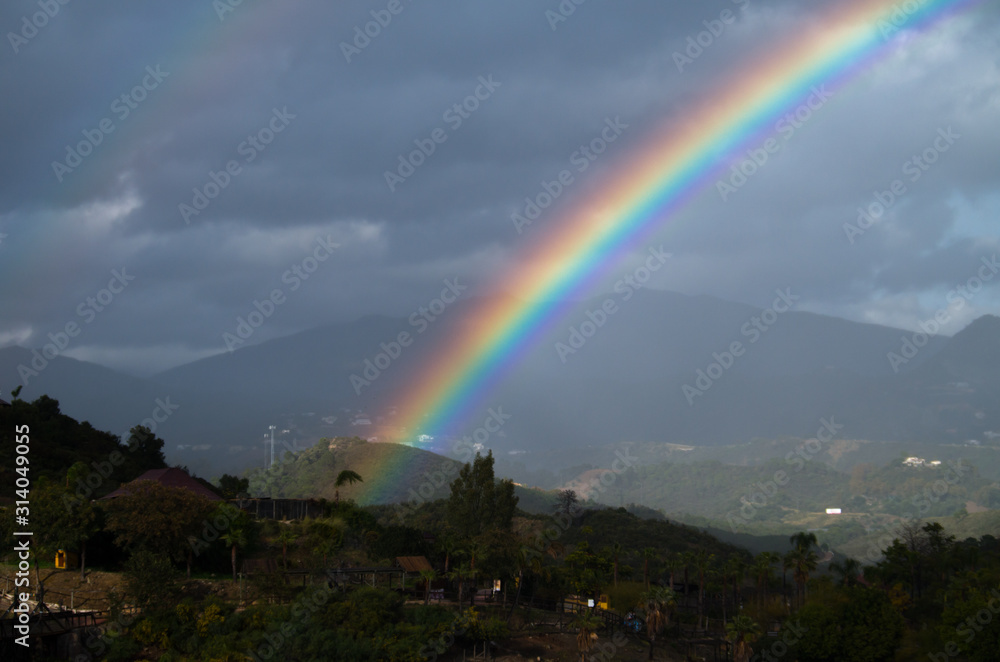 A rainbow is a meteorological phenomenon that is caused by reflection, refraction and dispersion of light in water droplets resulting in a spectrum of light appearing in the sky. A rainbow is a meteorological phenomenon that is caused by reflection, refraction and dispersion of light in water droplets resulting in a spectrum of light appearing in the sky.