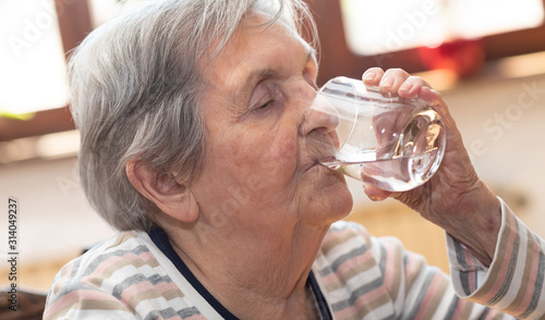 Elderly woman drinking water