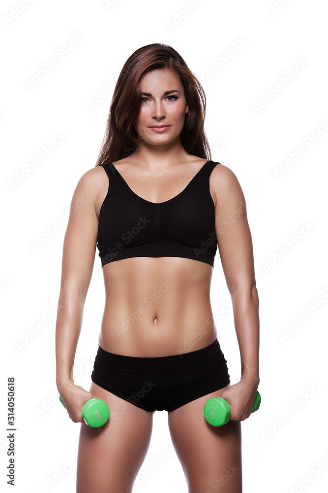 Fototapeta premium Fitness girl with dumbbells on a white background