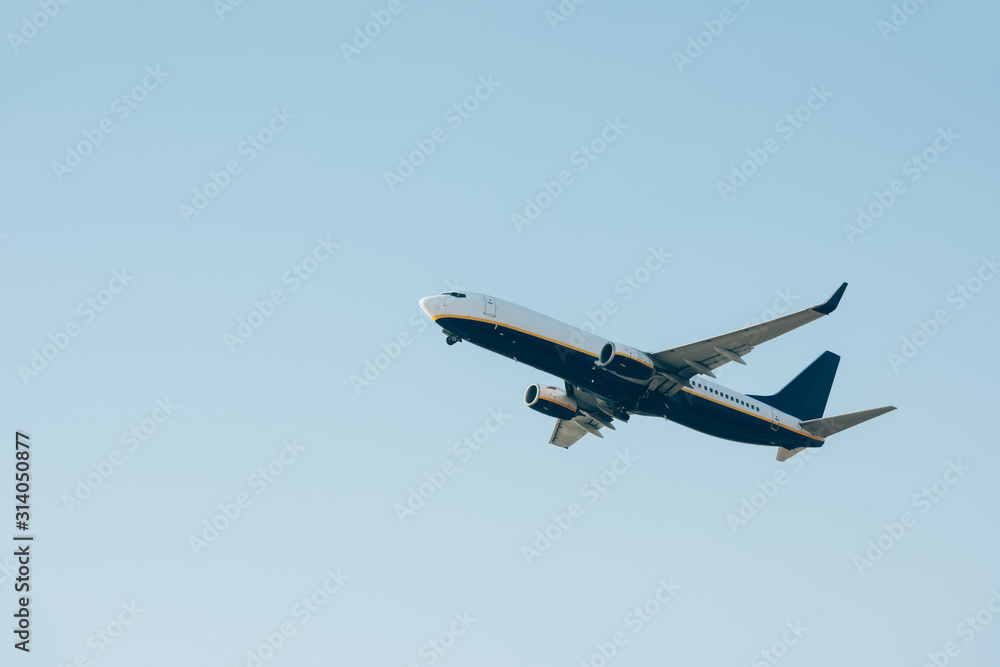 Low angle view of airplane departure in clear sky Low angle view of airplane departure in clear sky