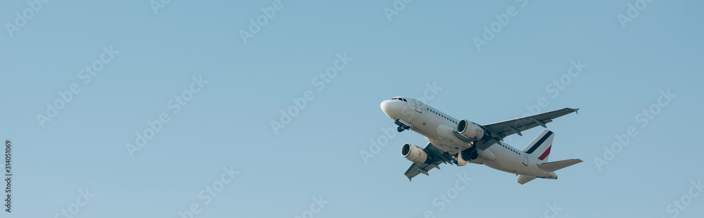 Flight departure of airplane in blue sky with copy space, panoramic shot Flight departure of airplane in blue sky with copy space, panoramic shot