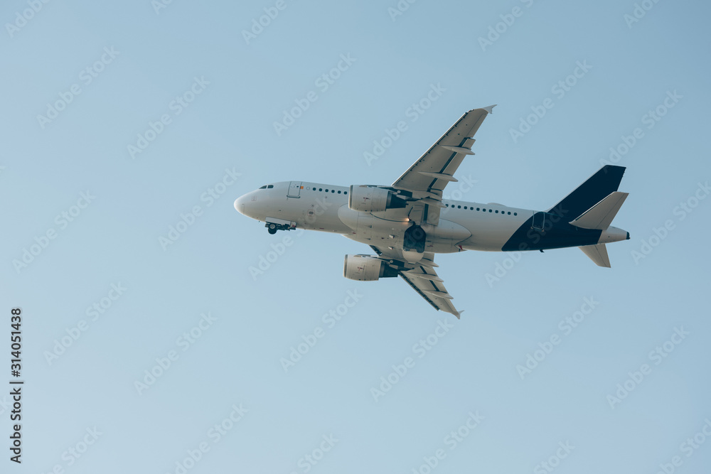 Flight departure of commercial plane in blue sky Flight departure of commercial plane in blue sky