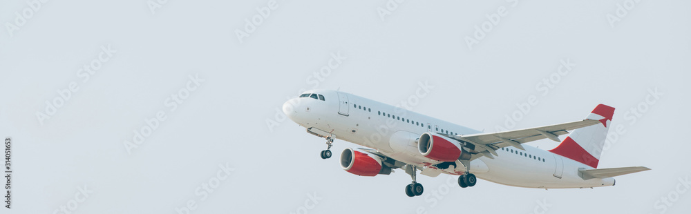 Fototapeta premium Departure of airplane with cloudy sky at background, panoramic shot