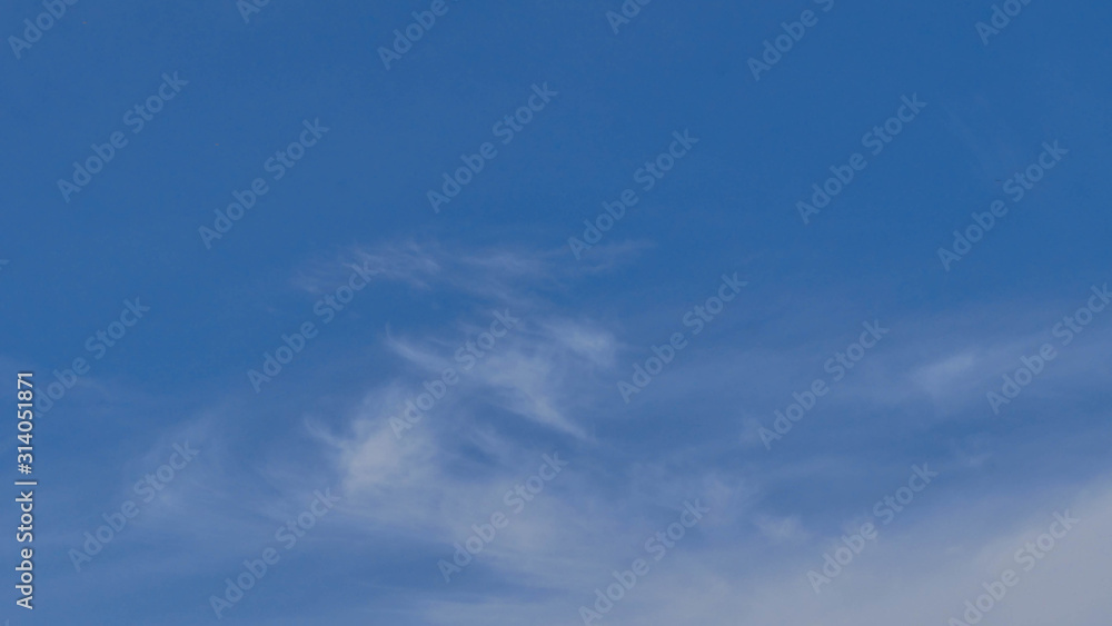 Fluffy white clouds on blue sky 