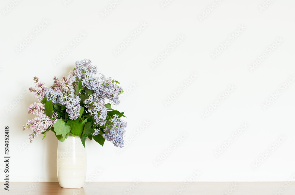 Home decor, lilac flowers in vase on a white wall background. Interior. - Image Home decor, lilac flowers in vase on a white wall background. Interior. - Image