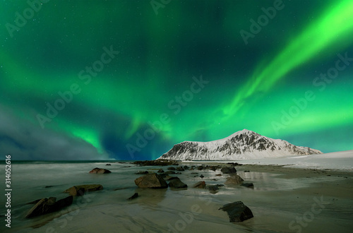 Aurora borealis also called northern lights over skagsanden beach in Norway © Piotr Krzeslak