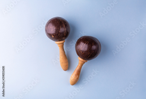 Two mexican maracas isolated on blue background. Traditional folk musical instruments. Elements of national culture. Flat lay. Latin music. © Cloudbursted