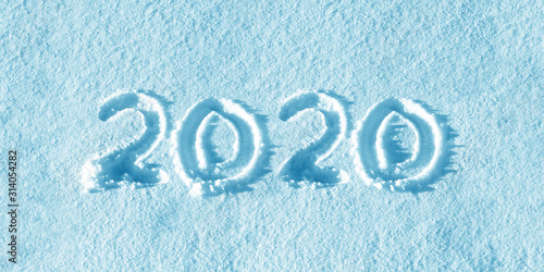 New year 2020, white snow background. Snowing, winter, new year concept. 2020 numbers written on snow field