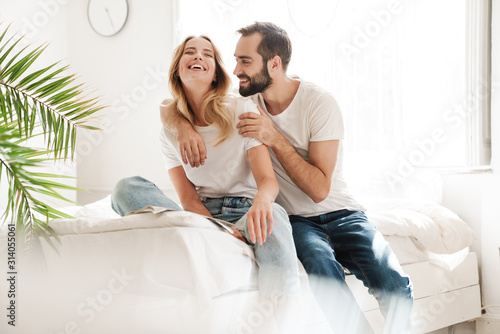 Happy young couple in love relaxing on a couch photo