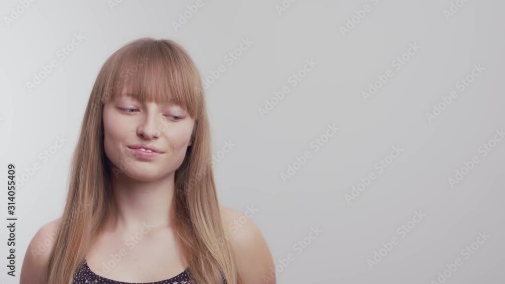 A Young Gorgeous Female Model Posing With A Sweet Smile On Her Face While Slightly Leaning Her Head To The Left - Close Up Shot A Young Gorgeous Female Model Posing With A Sweet Smile On Her Face While Slightly Leaning Her Head To The Left - Close Up Shot