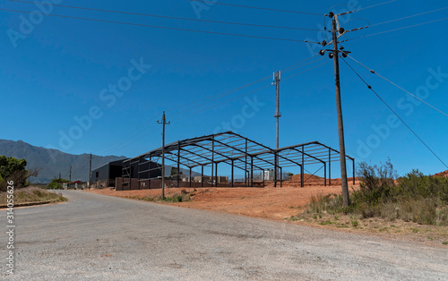 Swellendam, South Africa. December 2019. Metal construction of two barns on farmland in the Wstern Cape, South Africa photo