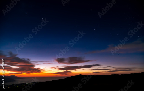 Starry Sky Sunrise with low lying clouds from Mount Bromo with a view of Mount Argopuro and G. Lemongan, Volcanoes in Java, Indonesia