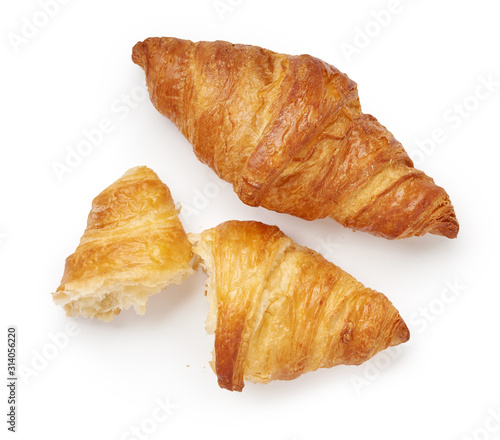 Two croissants with crumbs isolated on white background