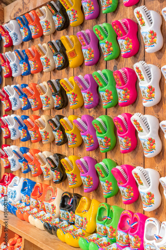 Typical dutch shoes used by farmers. Souvenirs of shoes in different shapes and colors sold in a tourist shop in Amsterdam. Symbol of the Netherlands