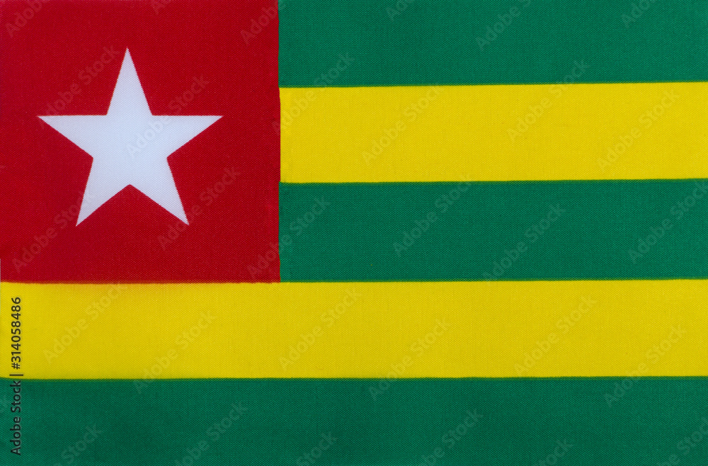 Flag of the Togolese Republic on a textile basis close-up Flag of the Togolese Republic on a textile basis close-up