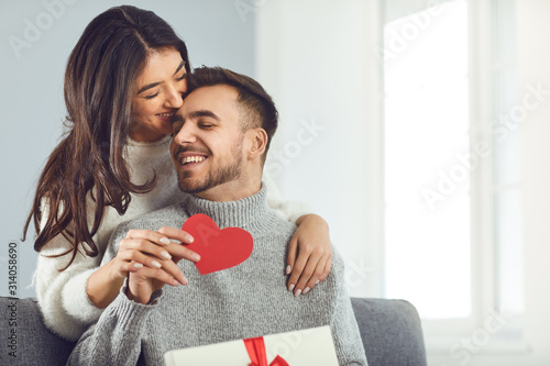 Valentine's day. Couple gives heart to the Valentine's Day in the room. photo
