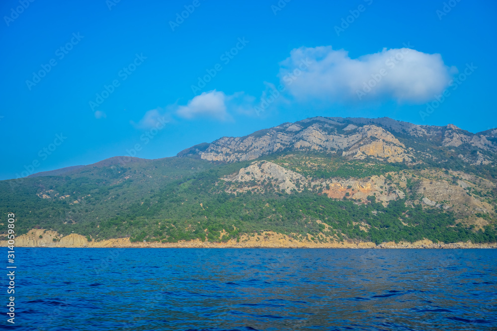 Seascape with views of the mountains near the coastline.