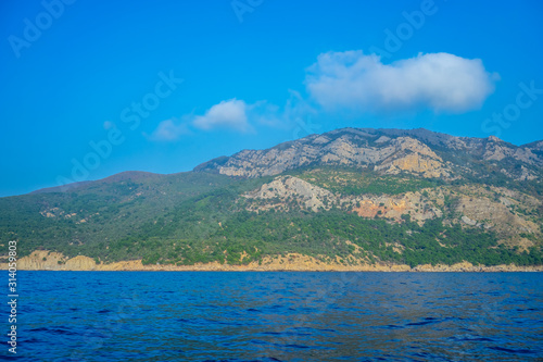 Seascape with views of the mountains near the coastline. © vvicca