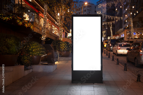 Blank billboard on night street photo