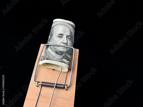 Принти на полотні Dollars in a mousetrap on a black background