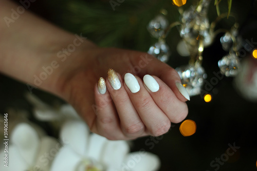 white nails with gold and silver glitter on a dark background, crystal, bokeh