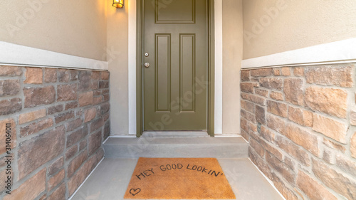 Pano Hey good looking words on the brown doormat by the front door of a home