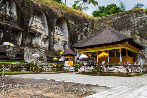 Funeral monuments of king Anak Wungsu and his favourite queens carved in the cliff of Gunung Kawi, with decorated autel, close to Ubud on Bali island, Indonesia. photo