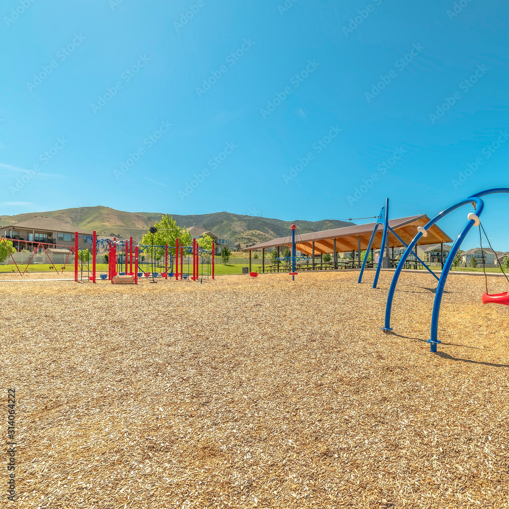 Square Timpanogos Mountains viewed from a park with colorful childrens playground Square Timpanogos Mountains viewed from a park with colorful childrens playground